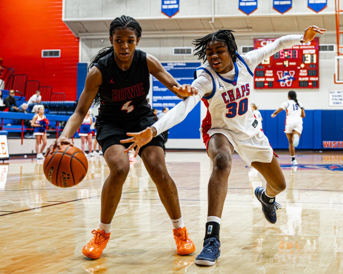 As she goes for the steal, forward/guard freshman Geralynn Byers-Veal fights for possession in the Bowie game Jan. 31. The undefeated Chaps beat Bowie 53-37.