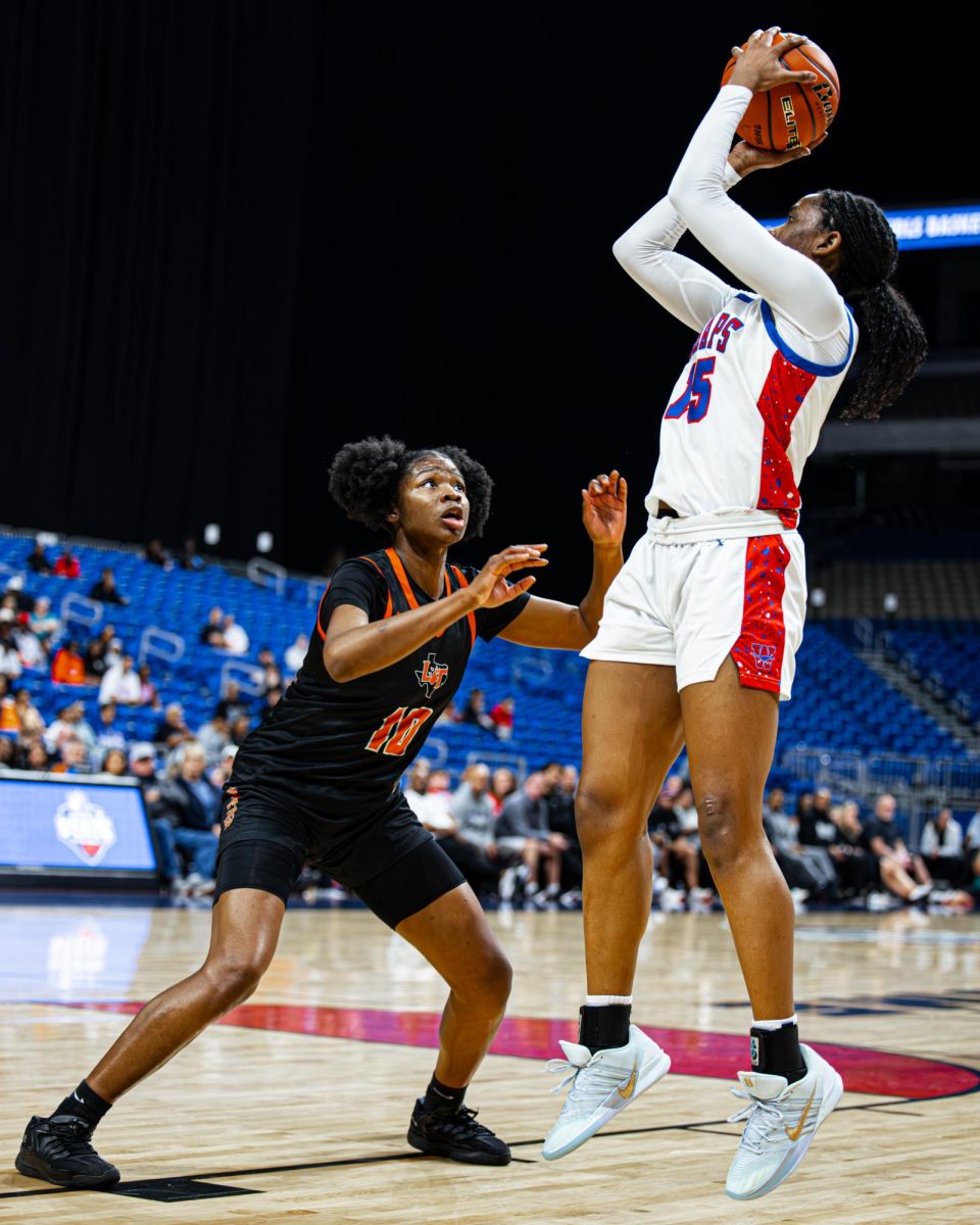 Senior forward Tamia King shoots a jumper in the State Championship against Lancaster at the Alamodome Mar. 6. King finished with a 14-rebound double-double