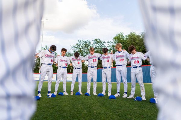 The Chaps pray in center field before the Chaps 10-4 win over the Dripping Springs Tigers April 22 at Woerner Field.